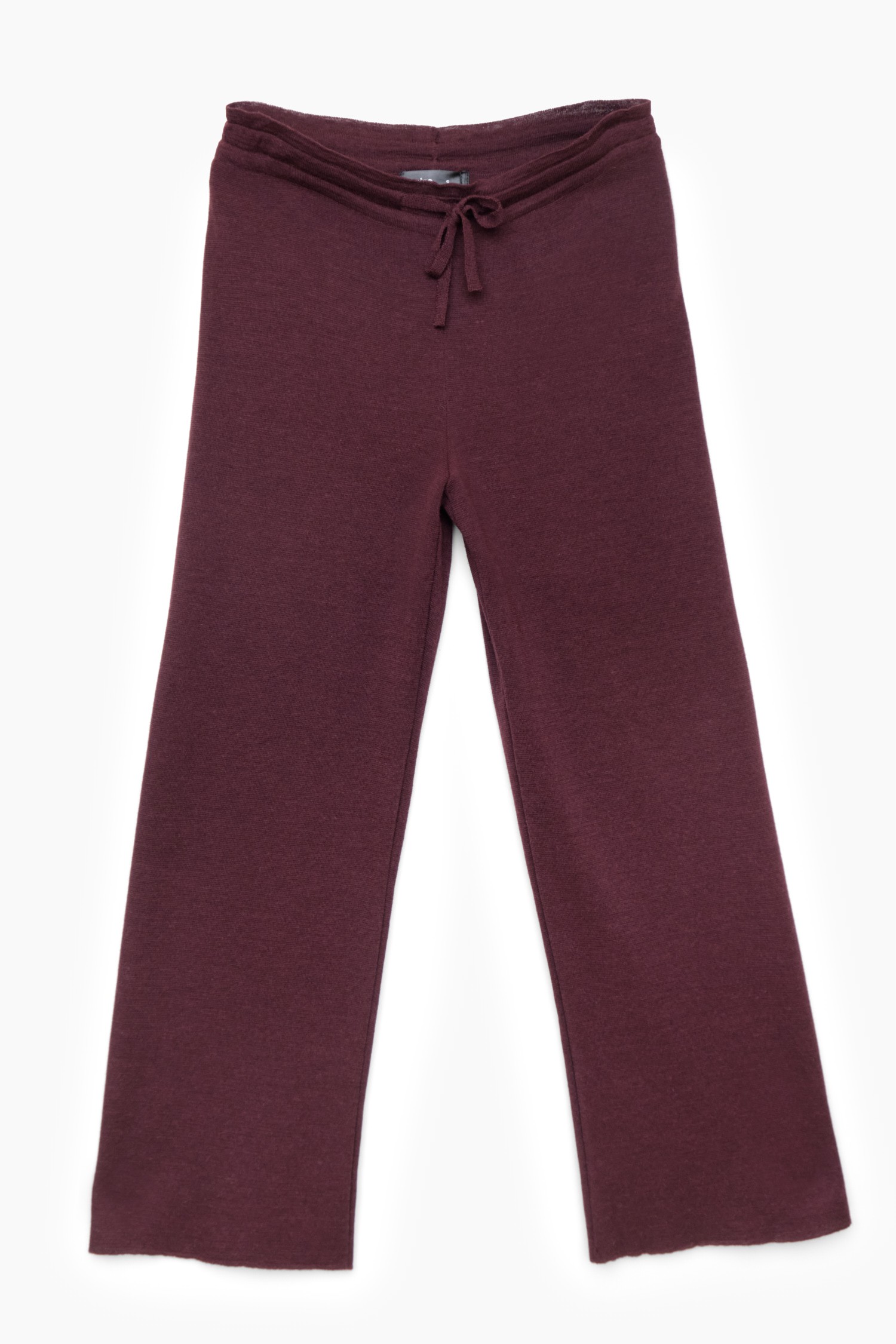 Fig coloured pants made from alpaca wool against a white background